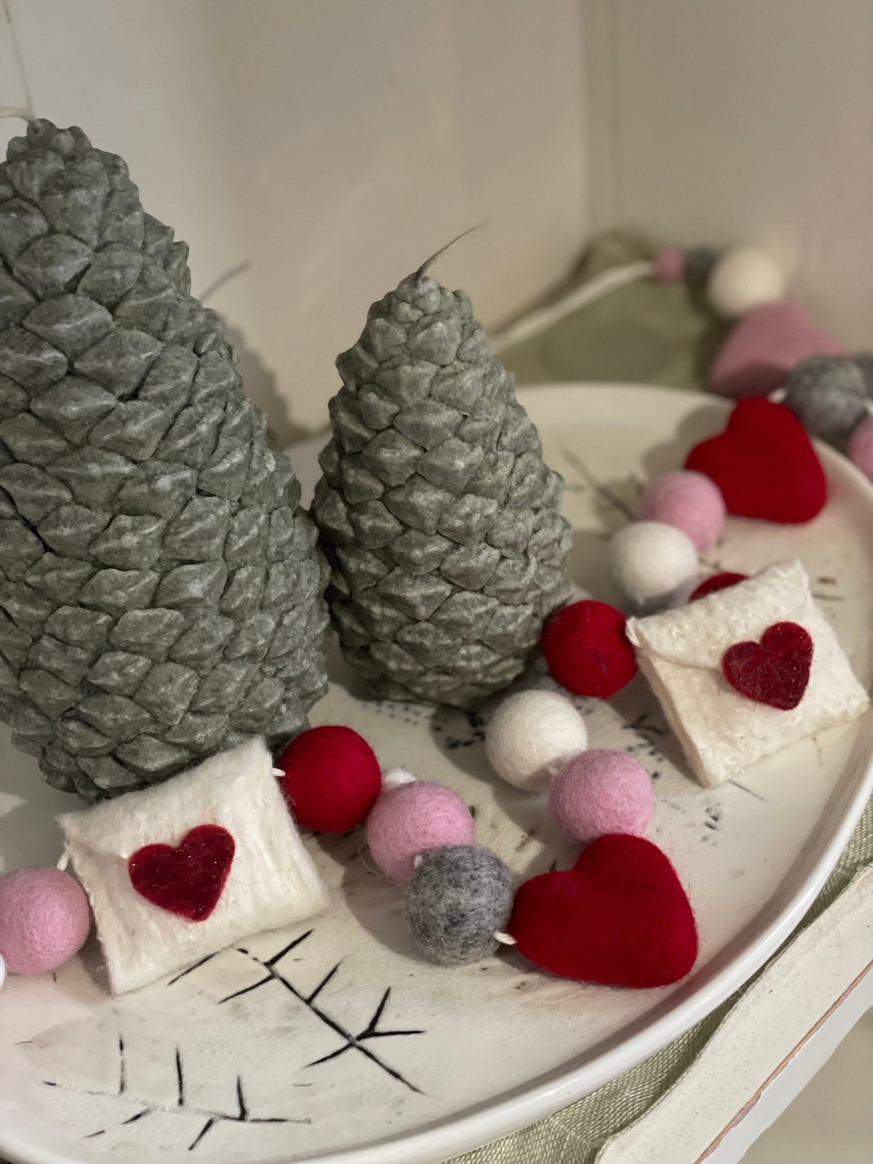 Decorative felt wool garland with red and pink hearts and love letters for Valentine's day.
