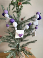 Decorative felt wool garland with purple hearts and love letters for Valentine's day.
