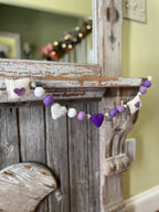Decorative felt wool garland with purple hearts and love letters for Valentine's day.