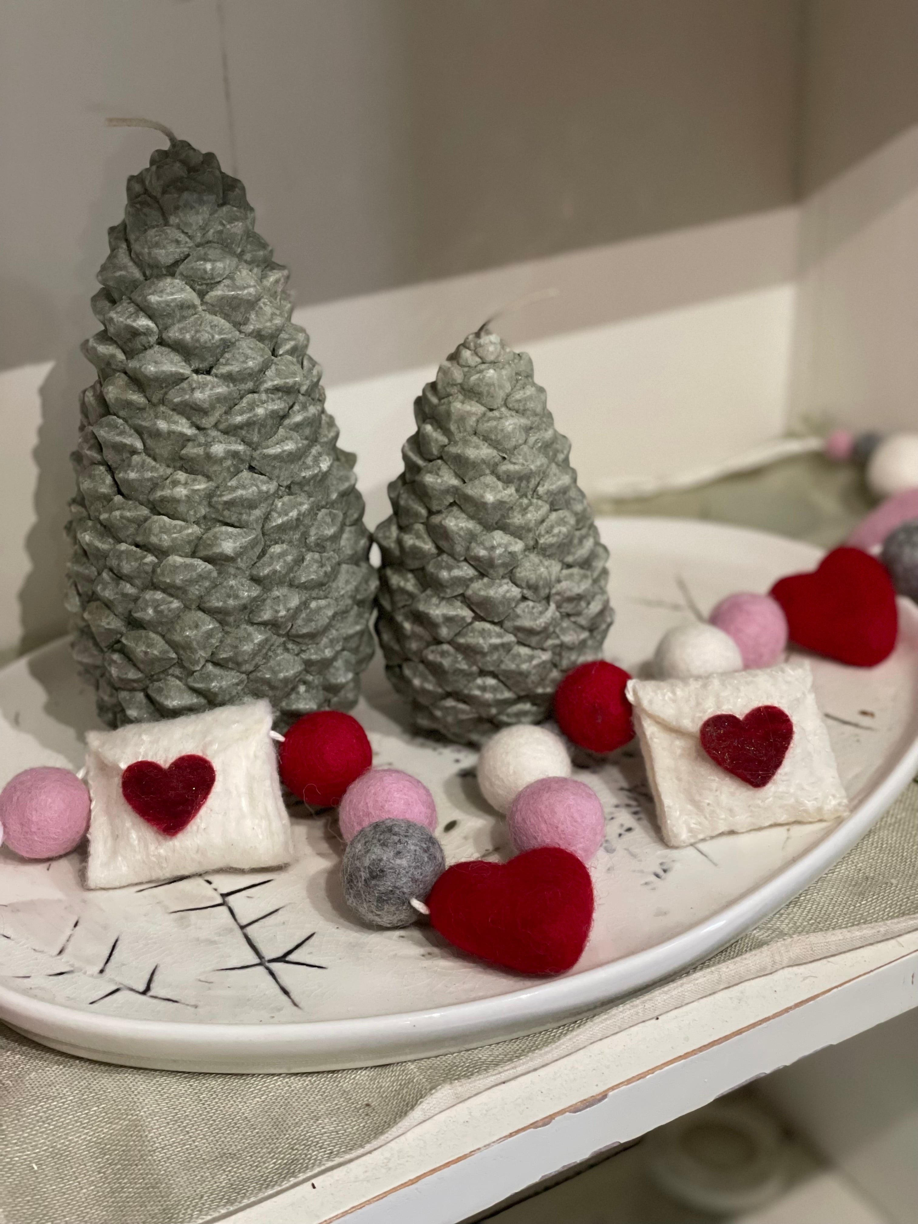 Decorative felt wool garland with red and pink hearts and love letters for Valentine's day.