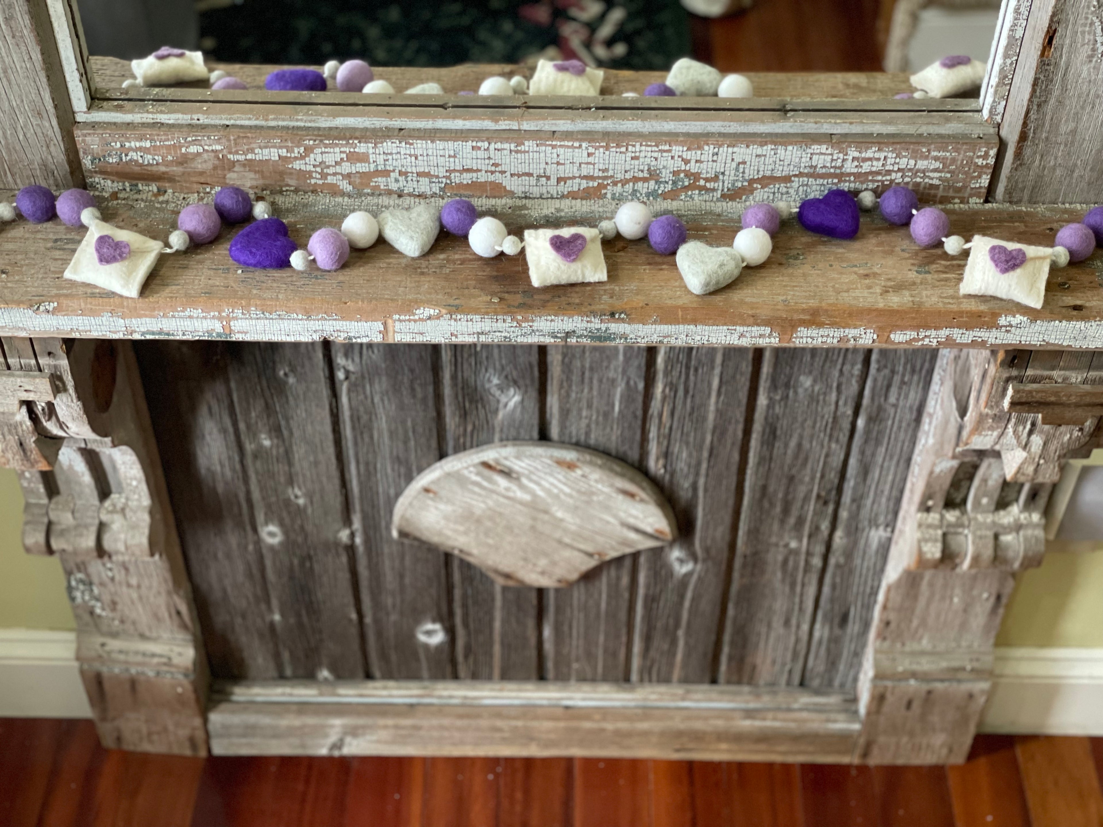 Decorative felt wool garland with purple hearts and love letters for Valentine's day.