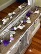 Decorative felt wool garland with purple hearts and love letters for Valentine's day.